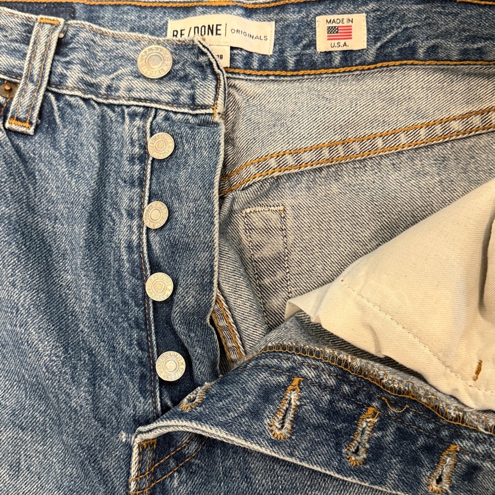 Re/Done Originals High Waisted Button Fly Blue Straight Leg Jeans with Raw Hem.